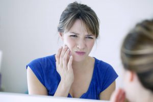 woman experiencing tmj and jaw pain