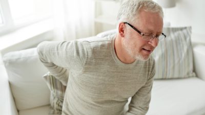 older adult experiencing back pain and sciatica