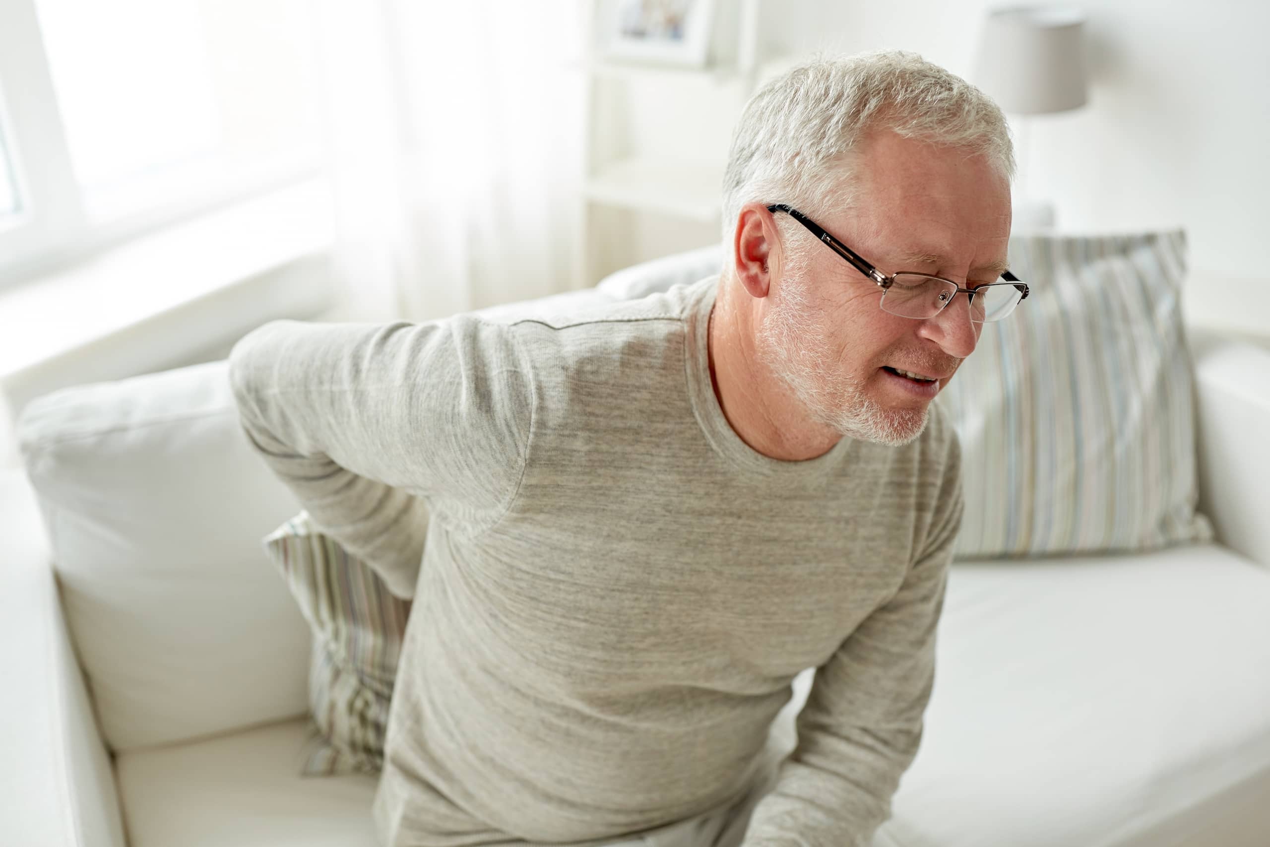 older adult experiencing back pain and sciatica