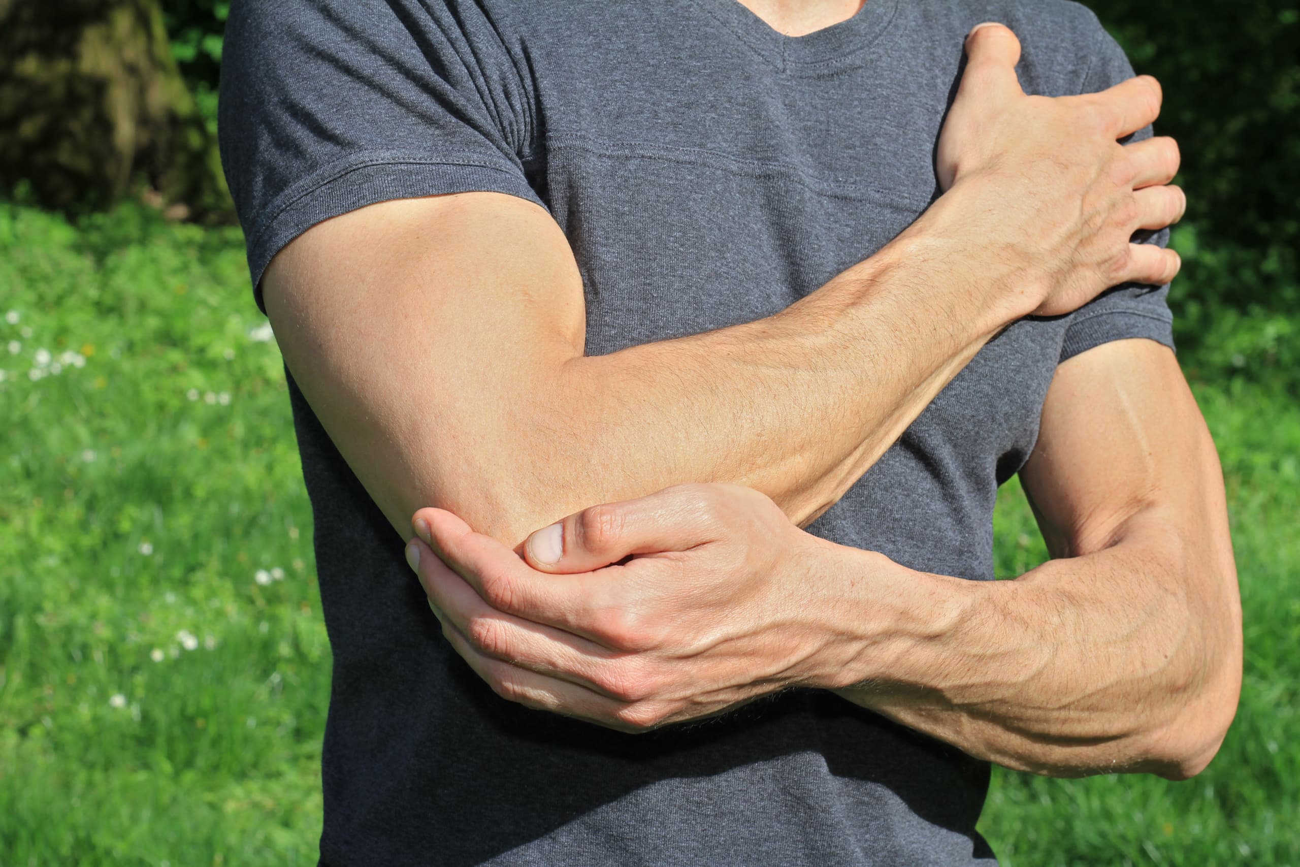 man holding sore elbow pain