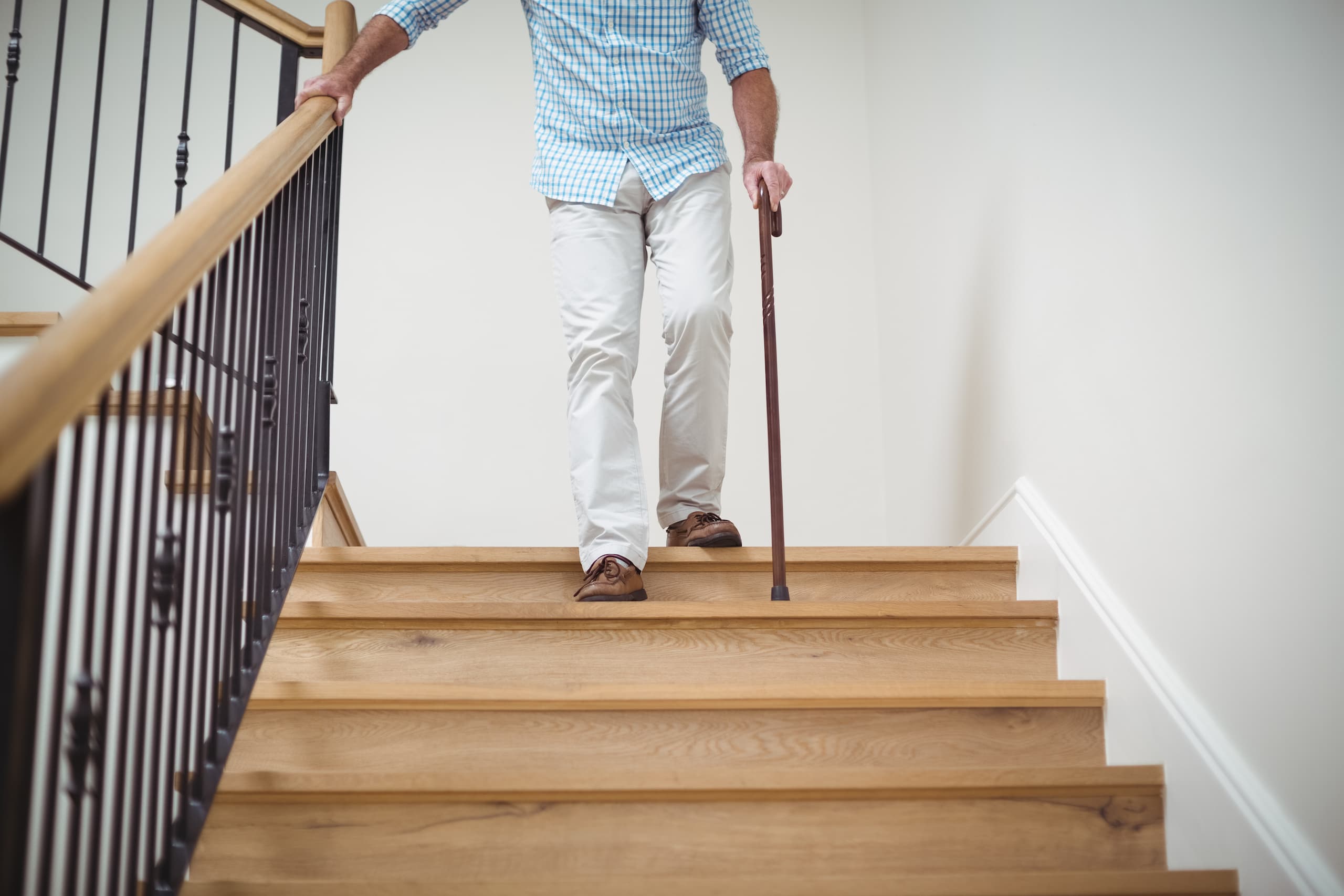 older adult going down stairs balance stability