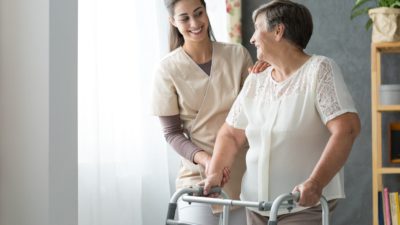 nurse and woman using walker