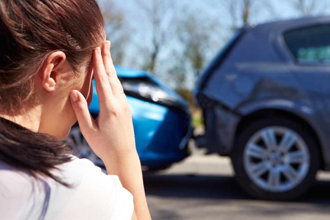 car accident treatment and physiotherapy | female looking at car accident_144026320