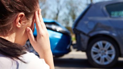 female looking at car accident_144026320