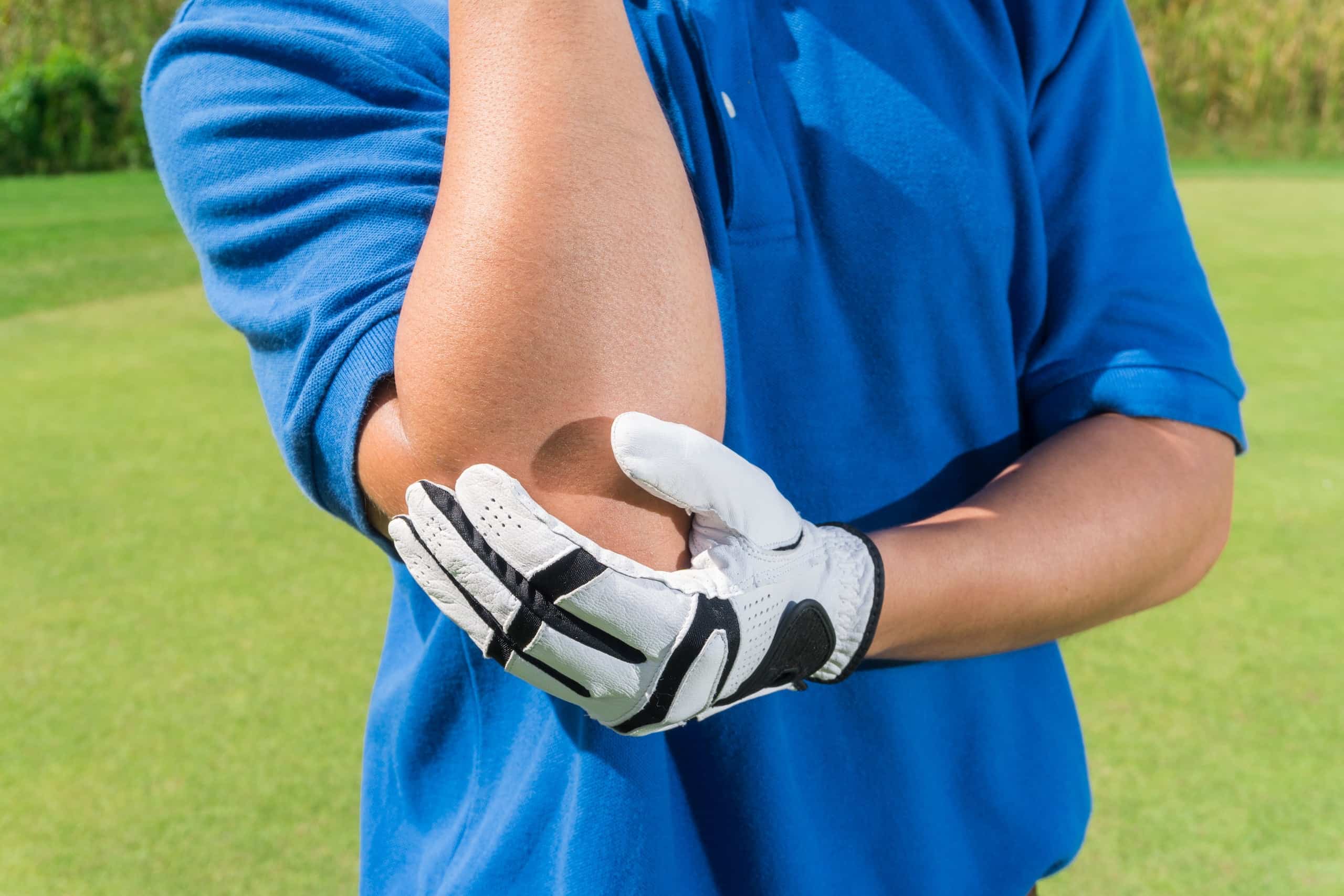 golfer holding sore elbow 514945474